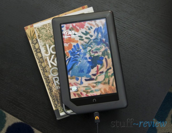 Nook Color ~ Hardware ~ Charging with USB cable on a pile of books