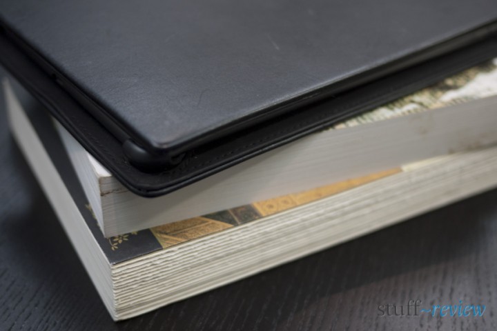 The Nook Color inside leather case on a stack of books