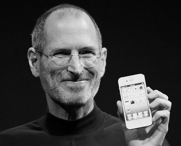 Steve Jobs holding and iPhone