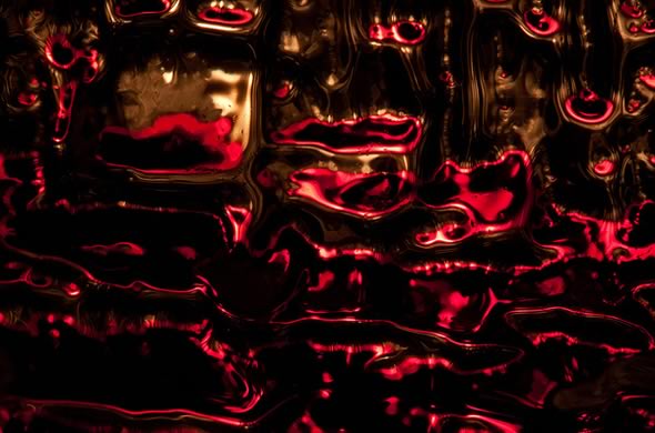 Macro shot of candle light through a glass of red wine
